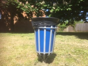 Blue litter bin with black liner and lid